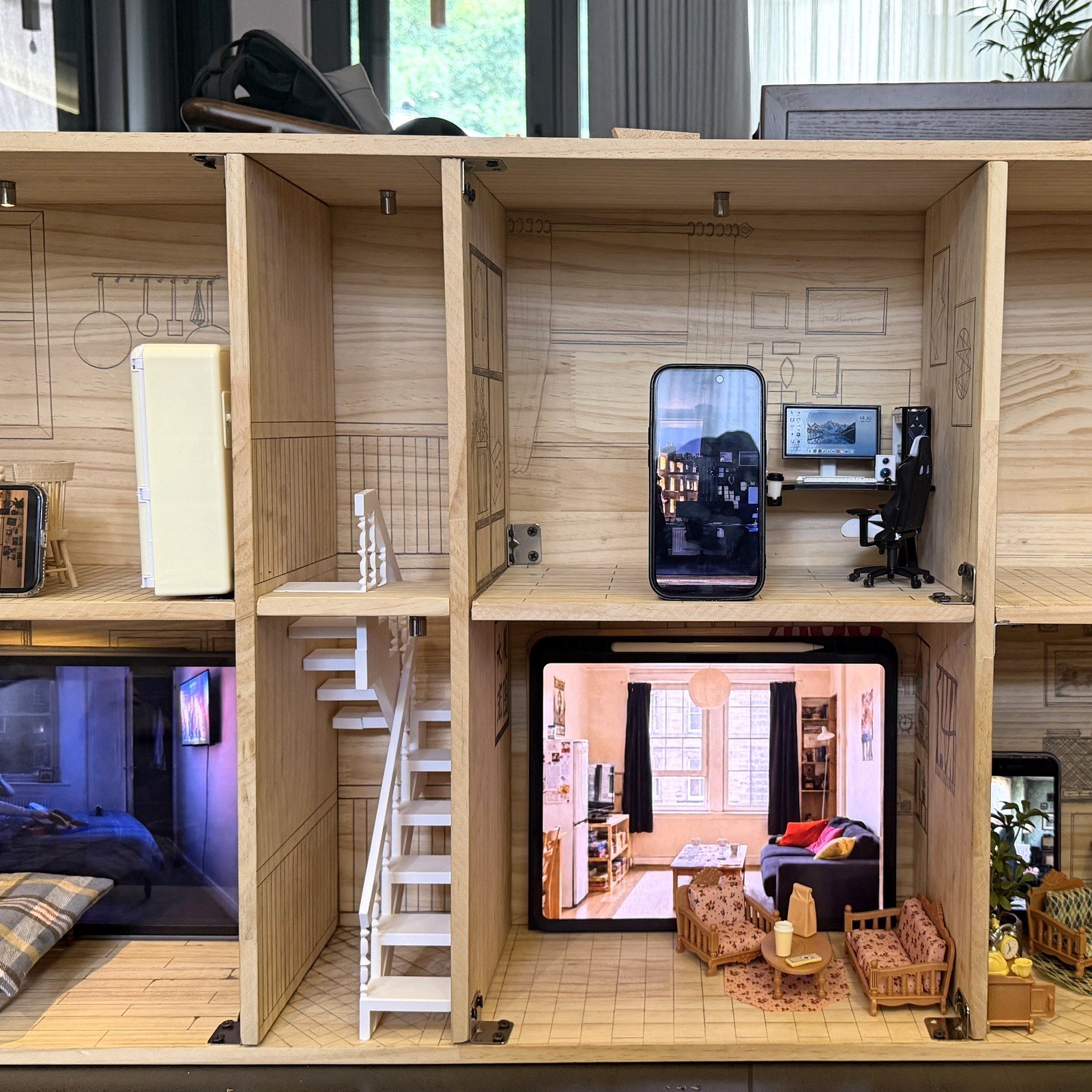 Wutopia: a wooden miniature apartment building containing screens and furniture