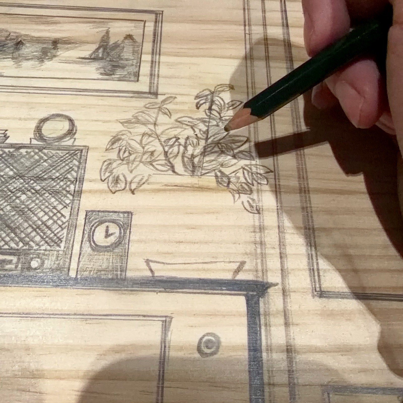 Pencil drawing on the wooden surface of the miniature installation